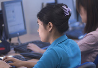 Cambridge tutors girl at computer