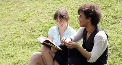 Students sitting by a river Students sitting by a river
